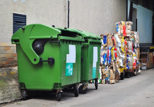 Workers sorting green waste and general rubbish during site clearance